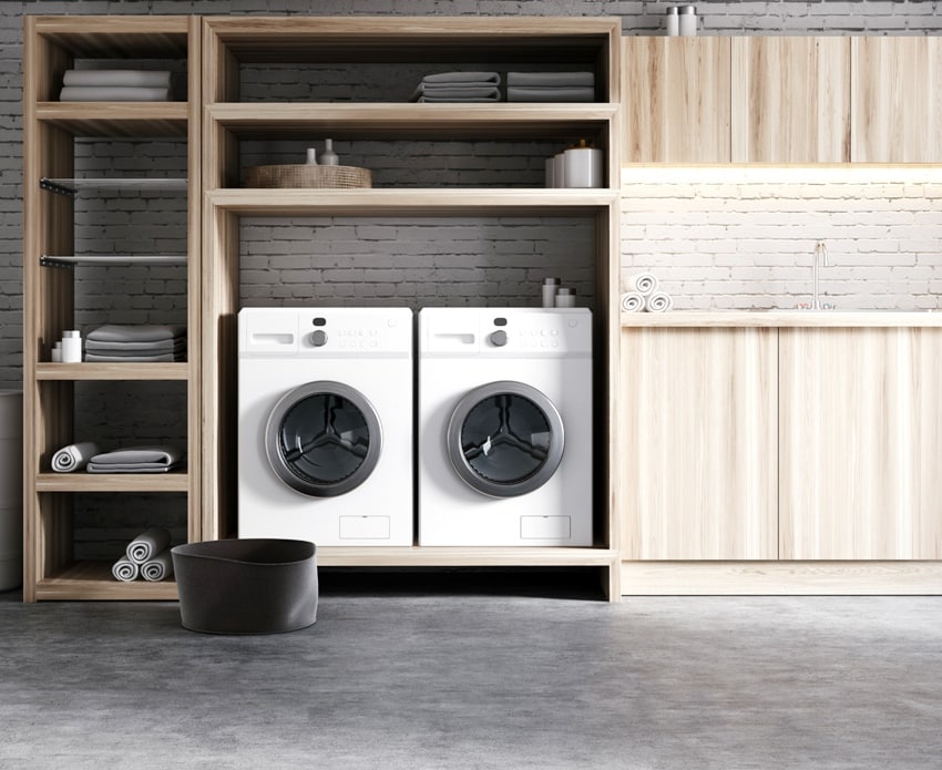 modern laundry room with white brick walls and concrete floors