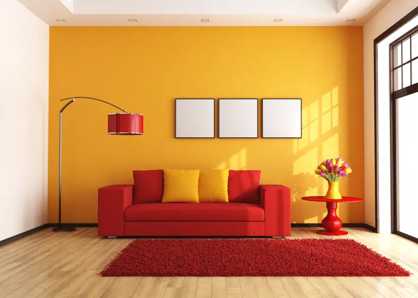 modern red and orange living room with floor lamp vase with flowers on small table and feathery carpet