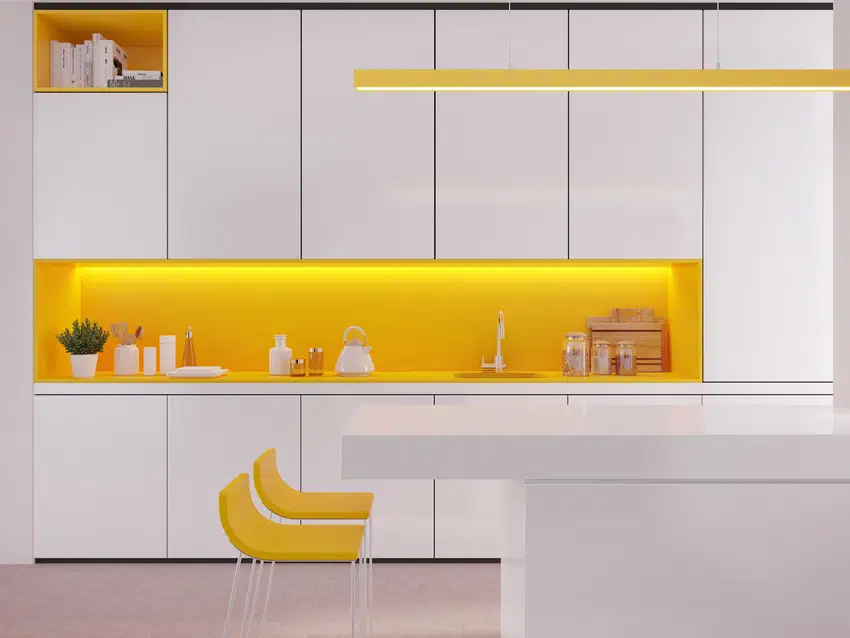Modern white and yellow kitchen interior with bar counter