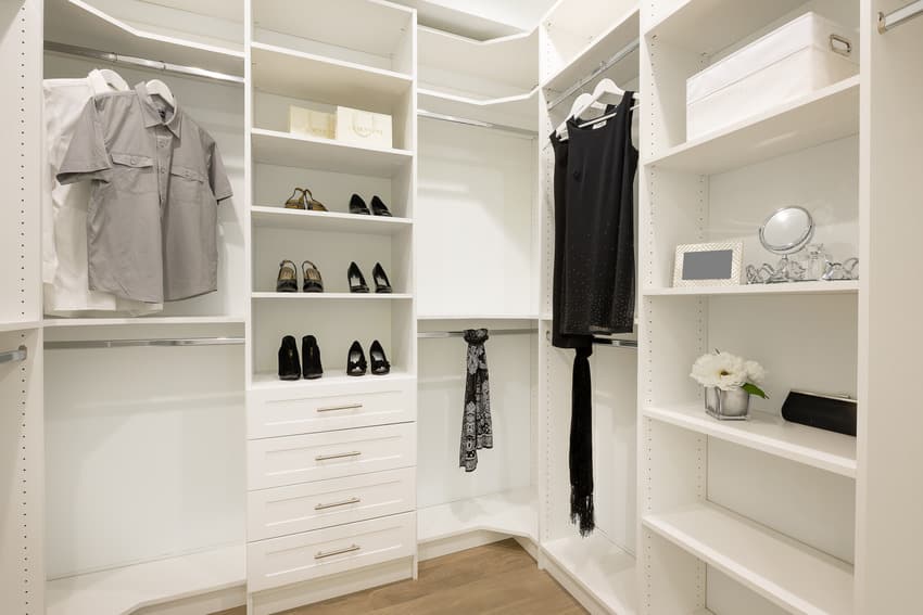 Modern white closet with clothes and shoes