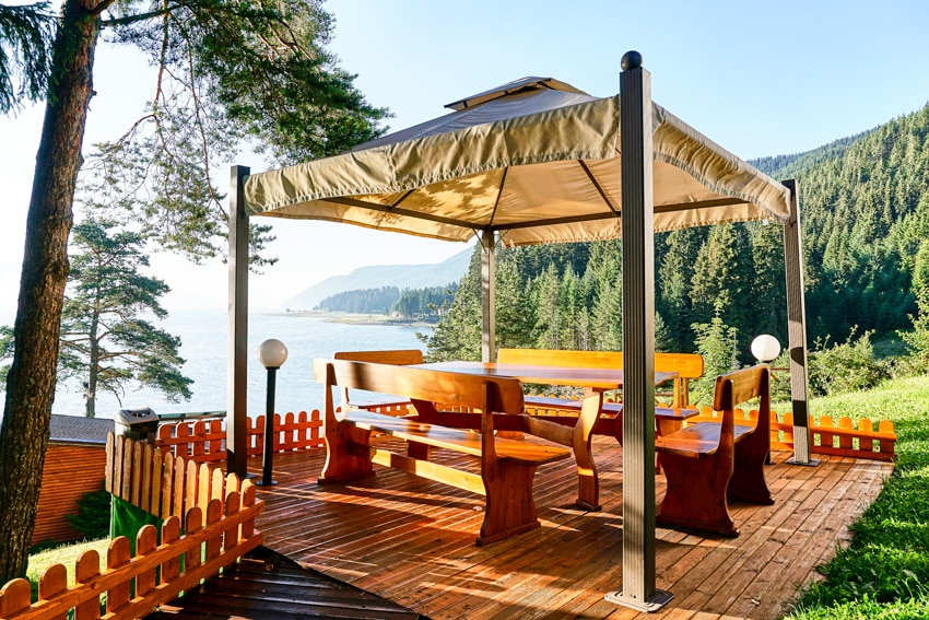 Outdoor wooden deck with canopy and furniture