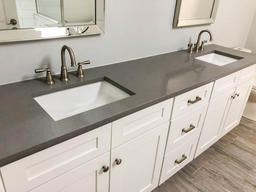 Pair of sinks set inside a concrete countertop bathroom