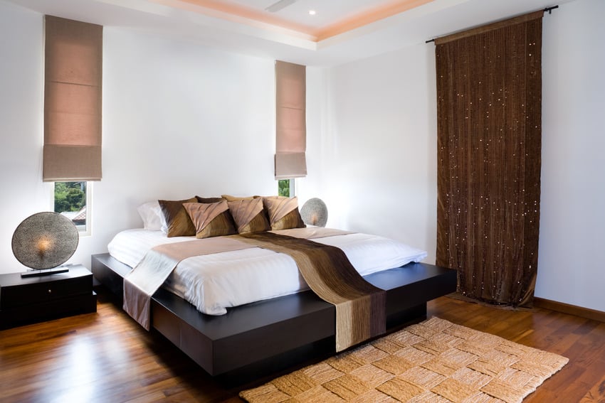Platform bed in a combination of beige and bright bedroom interior