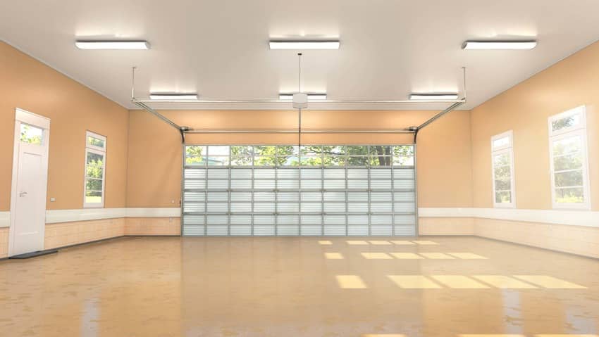 Polished concrete floor installed in a pastel garage interior