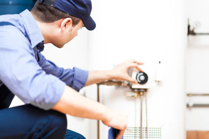 Professional plumber adjustment of heater