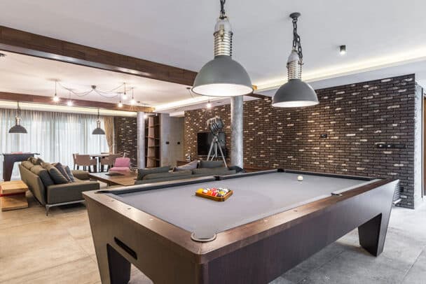 Recreational Room With Pool Table Dark Stone Cladding Pendant Lights Is 608x406 