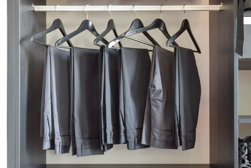 Row of pants hanging in a wardrobe