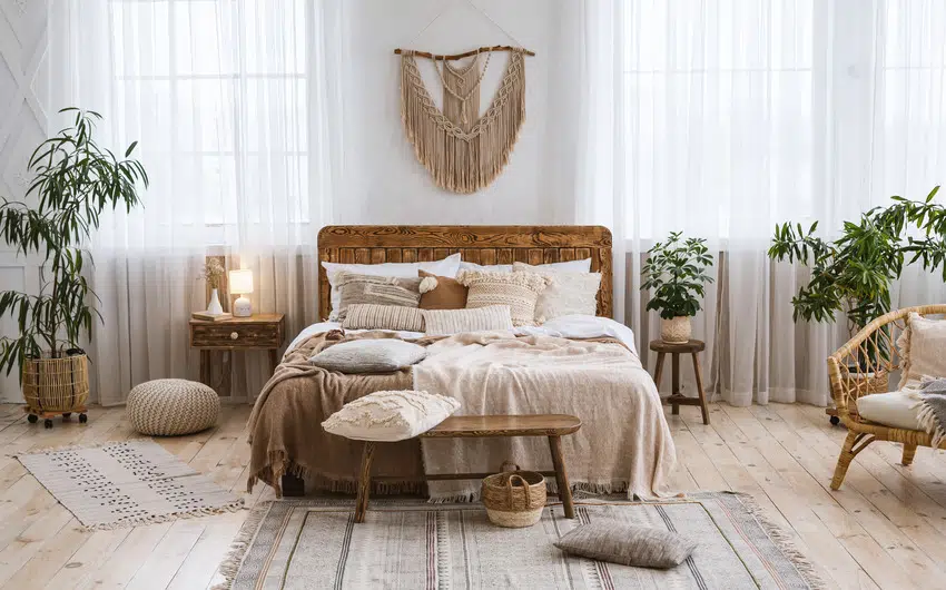 Rustic boho bedroom interior with plants rug and various decorative pieces