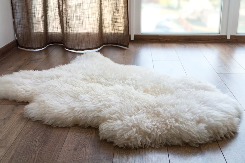 Sheep rug on wooden flooring