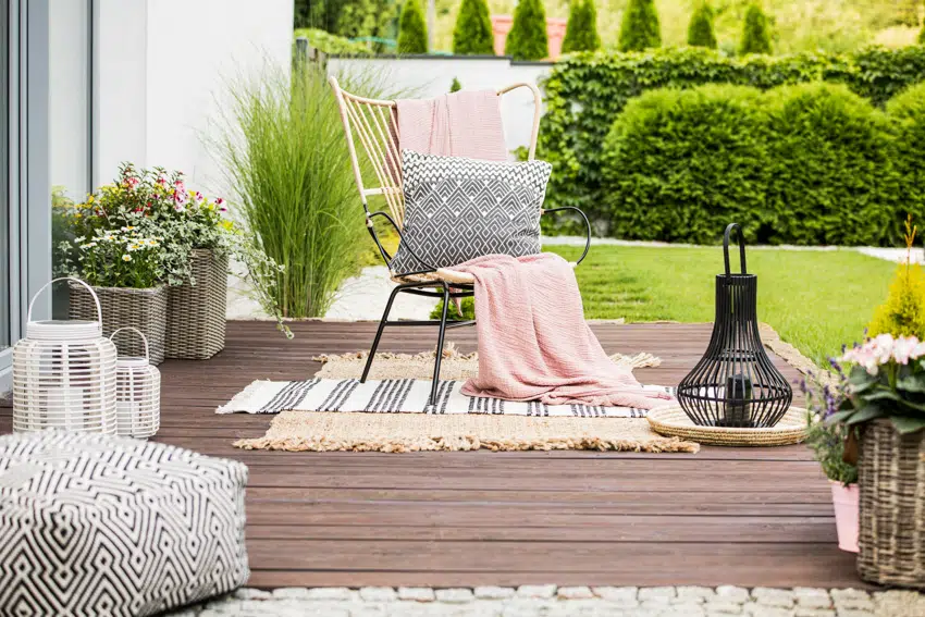 Small deck with dainty decorative elements and chair