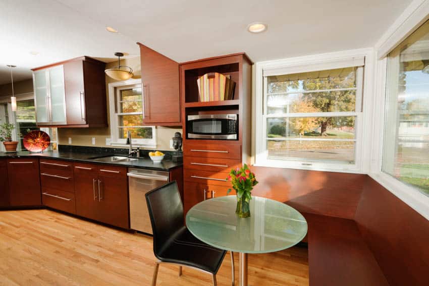 Small kitchen with round table and booth