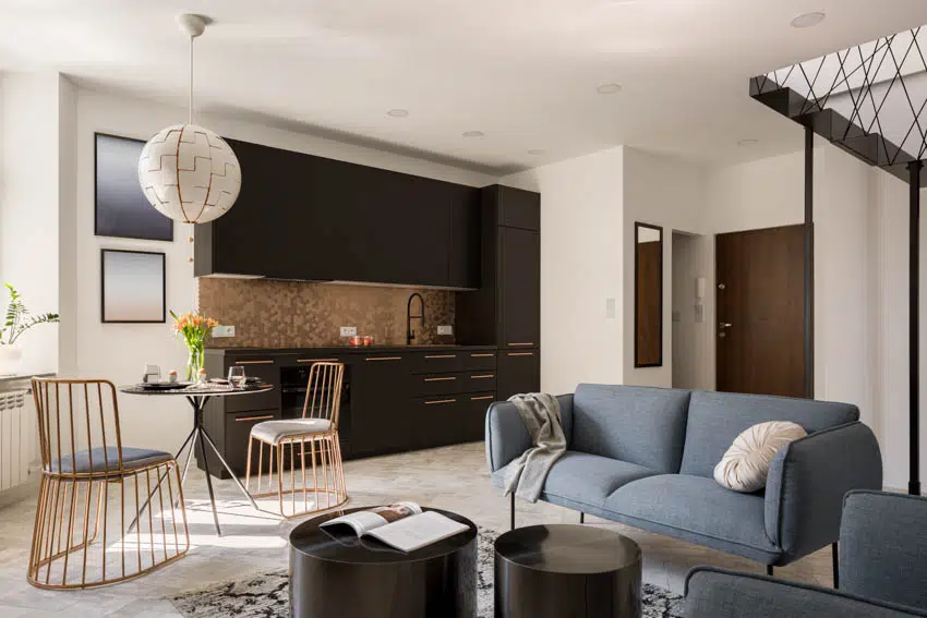 Small modern kitchen dining and living room with gold hexagon peel and stick backsplash