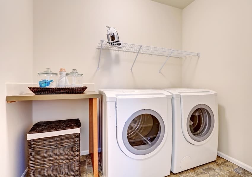 small space garage laundry with white appliances and wicker basket