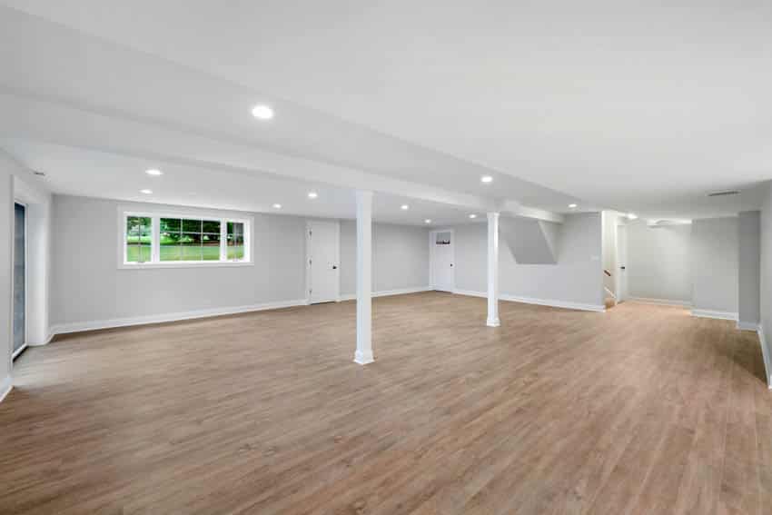 Spacious basement with wooden floors and white wall and ceiling