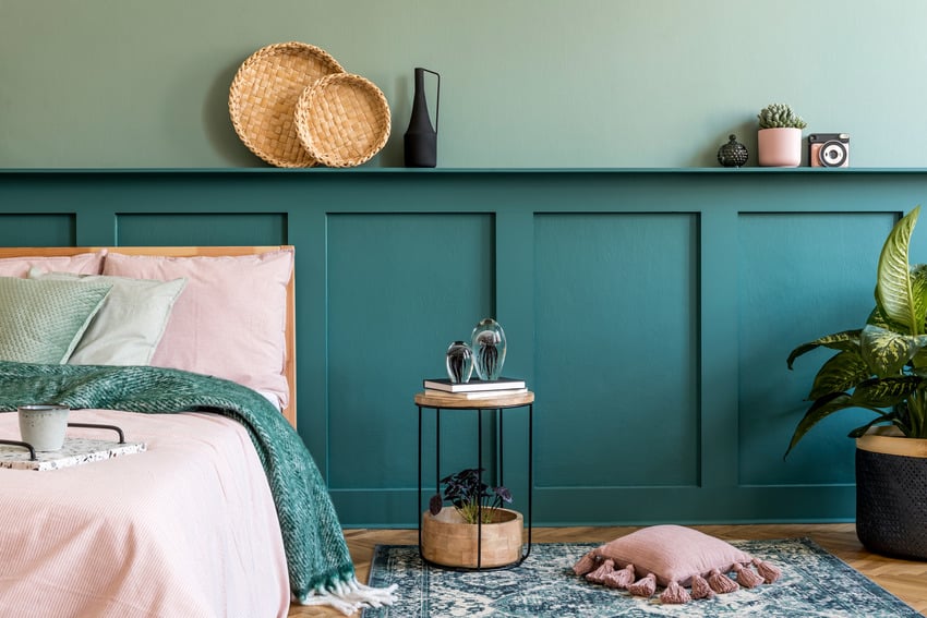 Teal and pink interior with wooden shelf and various decorations