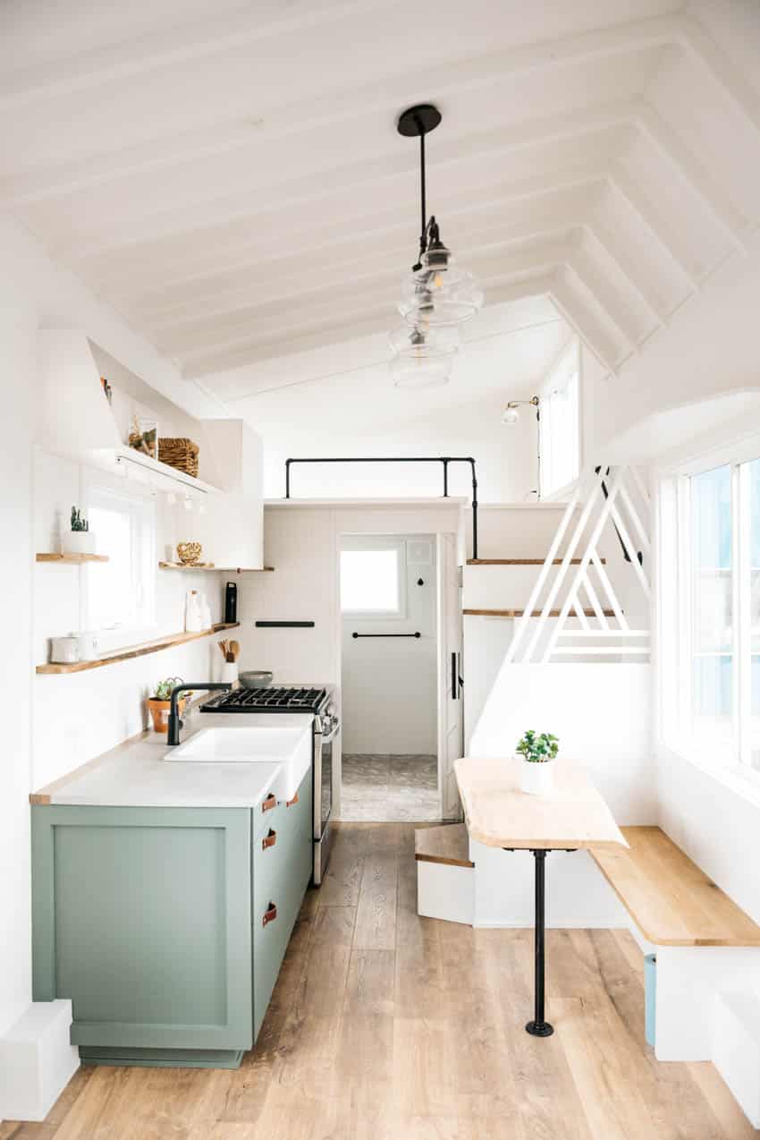 Tiny kitchen with booth sink and shelves