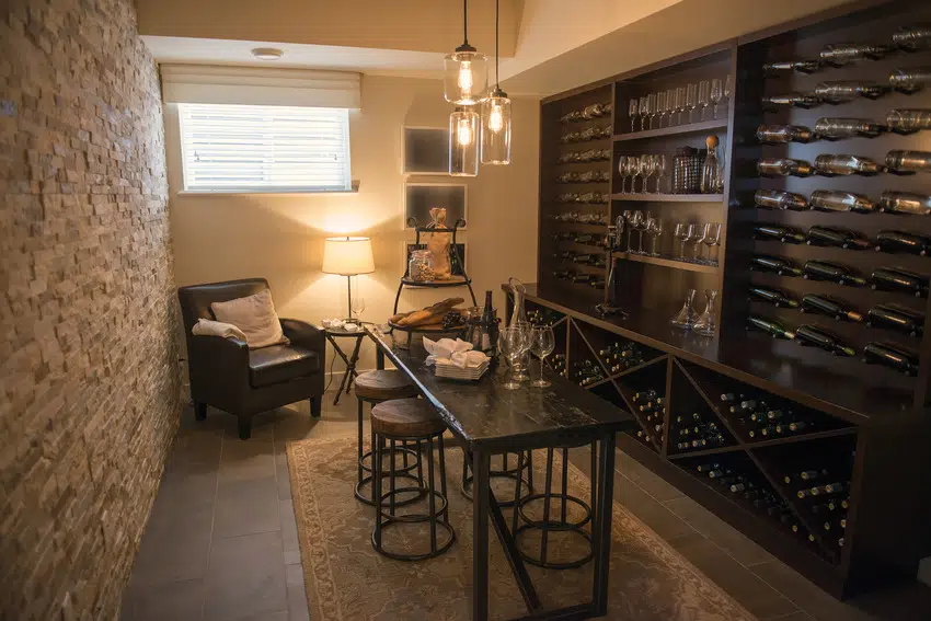 Wine closet room with sofa chair and table 