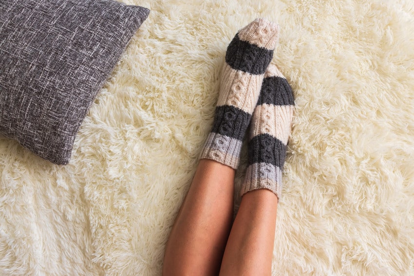 Woman's feet on plush carpet
