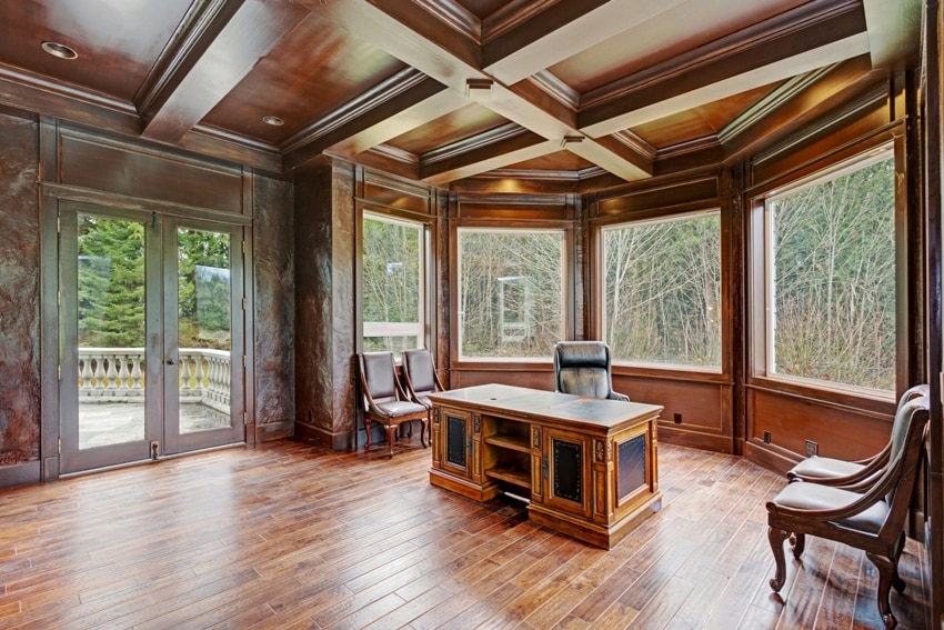 wood paneled home office features coffered beam ceiling