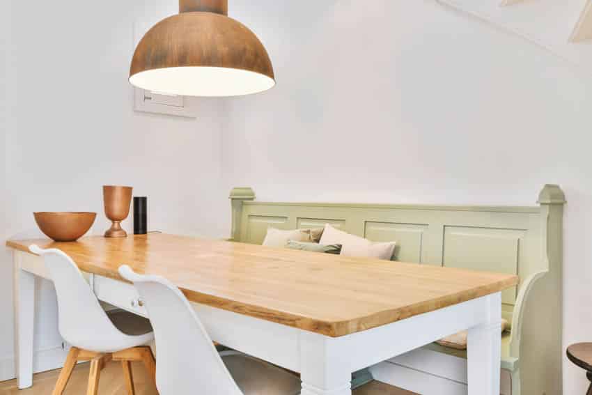 Wooden table kitchen booth hanging light white chairs