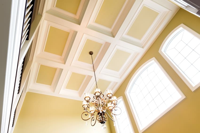 yellow coffered custom ceiling and walls with chandelier
