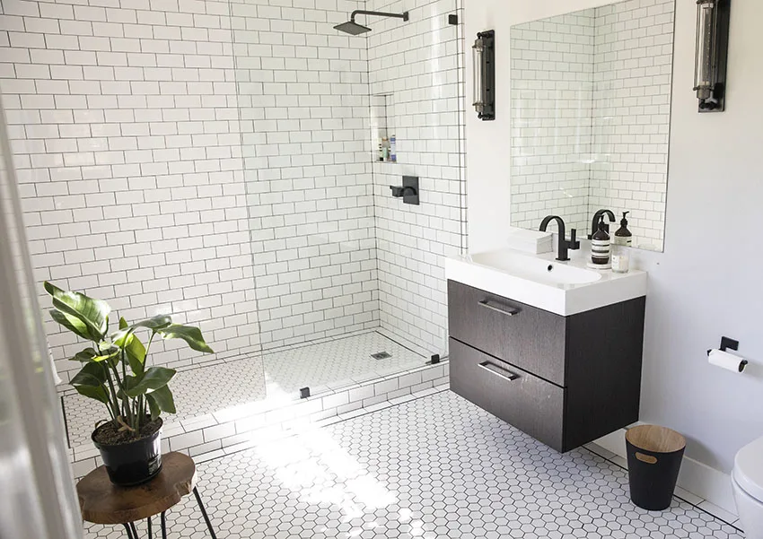 Bathroom with frameless glass shower door single sink vanity is