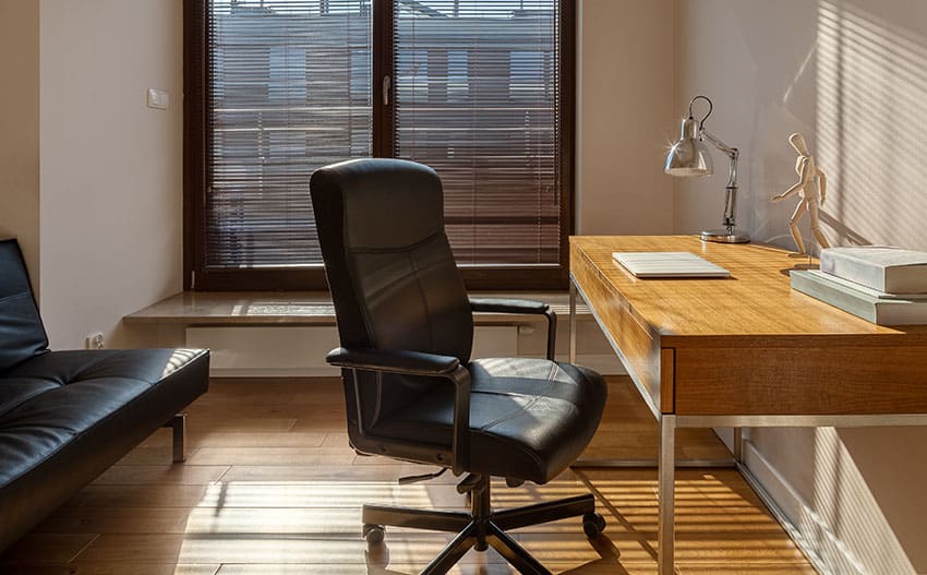 Office with steel frame desk, modern lampshade and window blinds