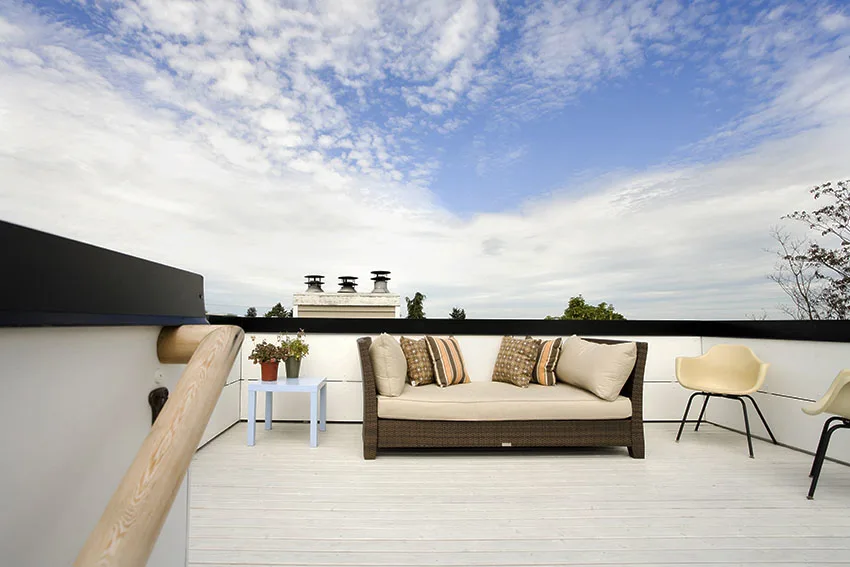 Rooftop with silicone roof coating and rattan sofa