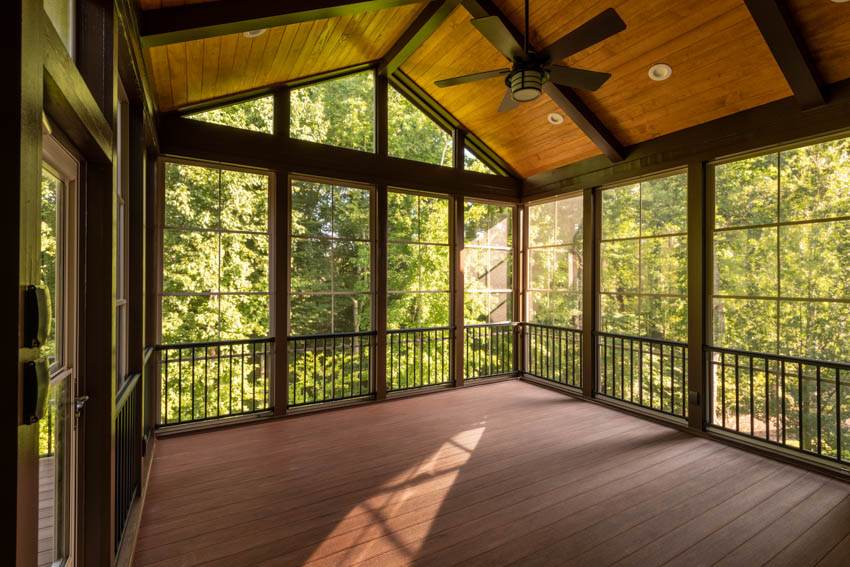 Bare porch turned into room wood floor ceiling windows