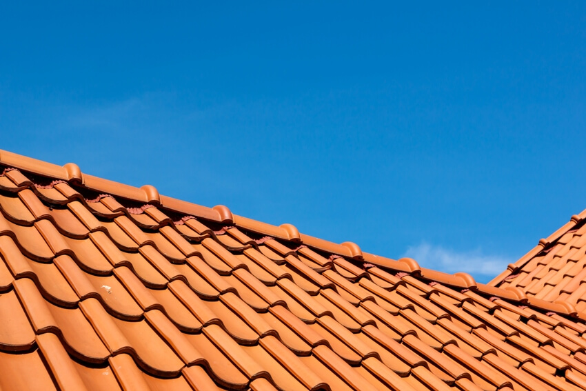 Barrel roof tile pattern over blue sky