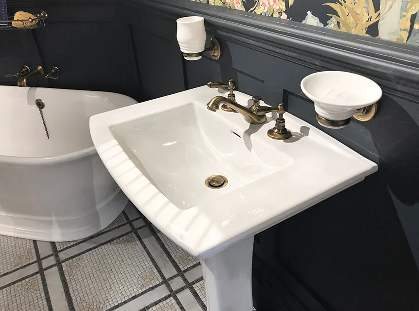 Bathroom pedestal sink black wainscoting