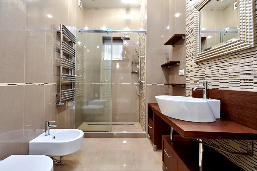 Beautiful tiled bathroom interior with wooden shelves and cabinets