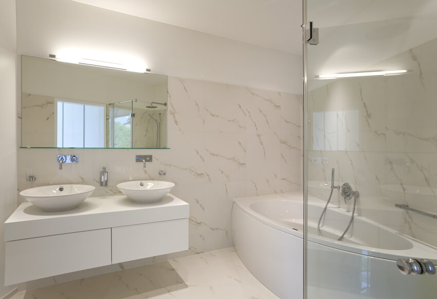 Bathroom with vanity with dual sink and tub