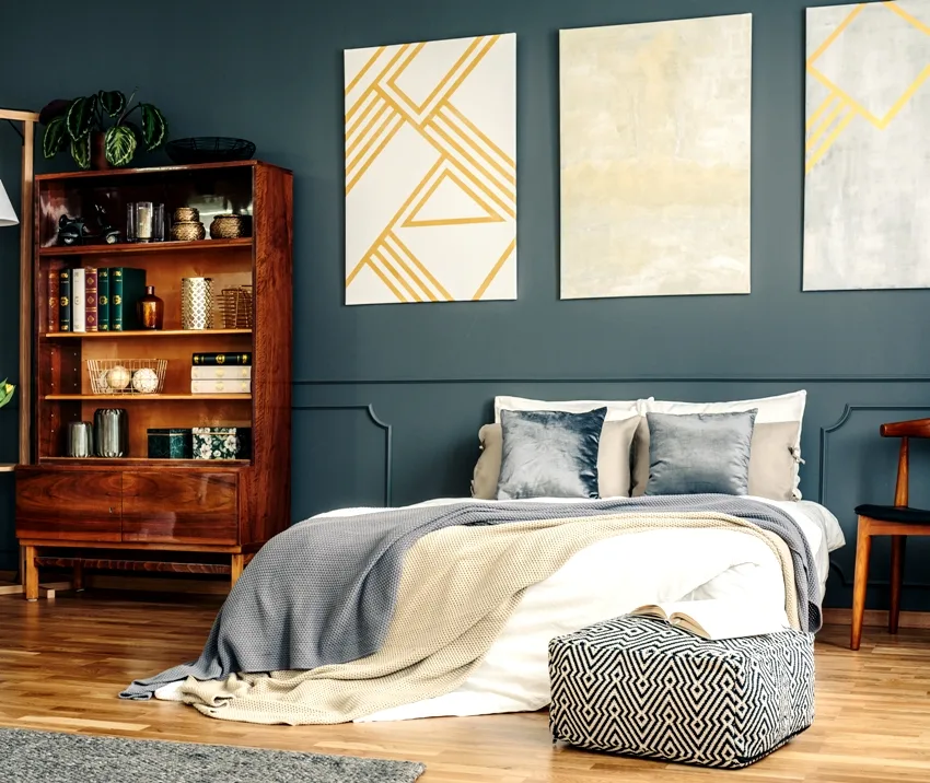 Bedroom interior with cherry wood shelf bed with blanket wooden floors and painting decorations on wall