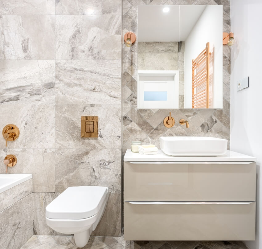 Beige bathroom with marble style tiles and copper details 