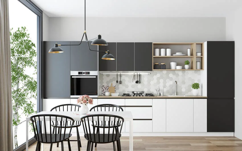 Black and white kitchen with hanging lights and large glass window wood floor