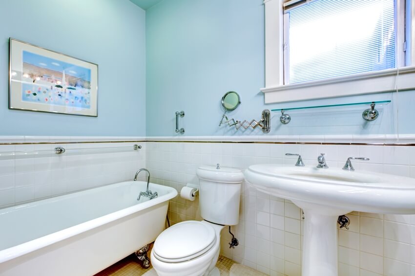 Blue antique elegant bathroom with white tub and tile