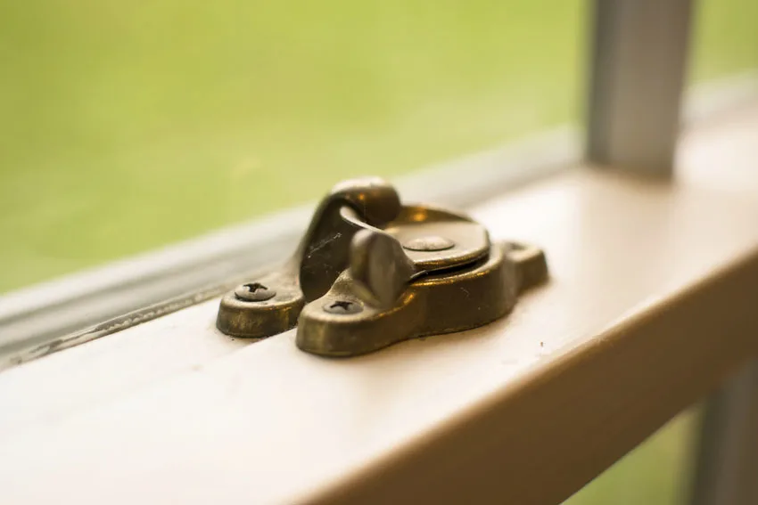 Brass thumb window lock