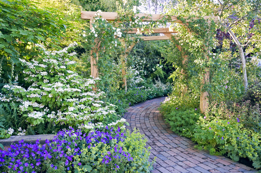 Brick garden walkway leading to arbor space