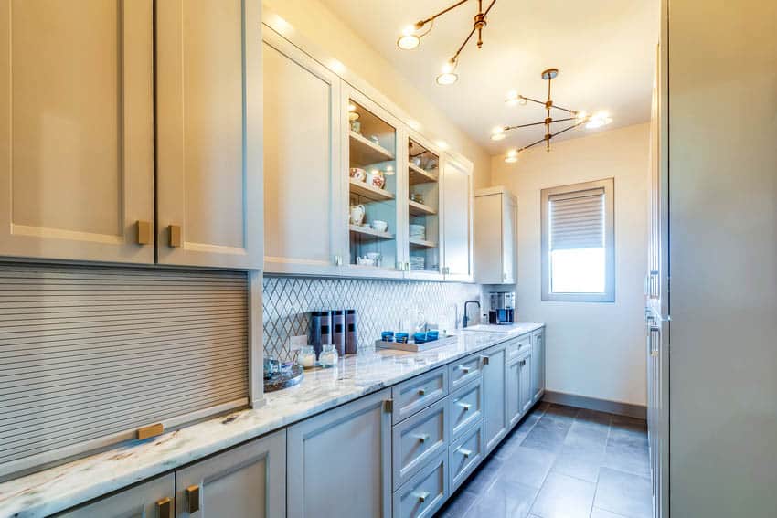 Butler pantry and laundry room with elegant light fixtures