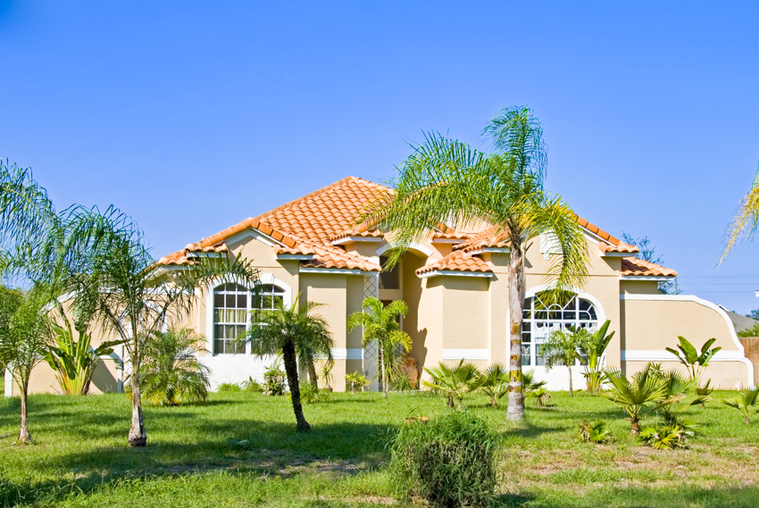 Classic spanish style house landscaped lawn palm trees