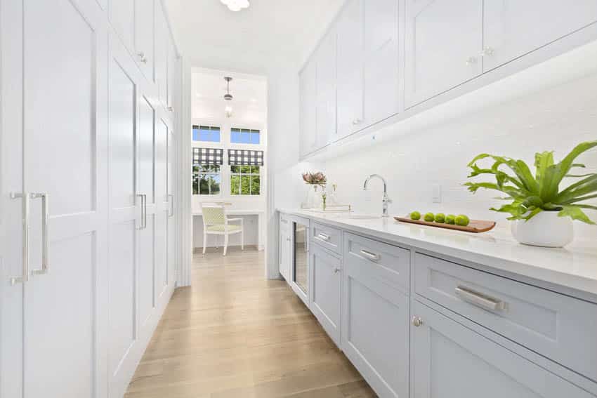 Classic white butlers pantry interior with wood flooring