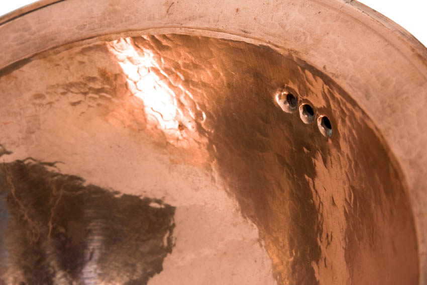Close up of hammered copper finish sink