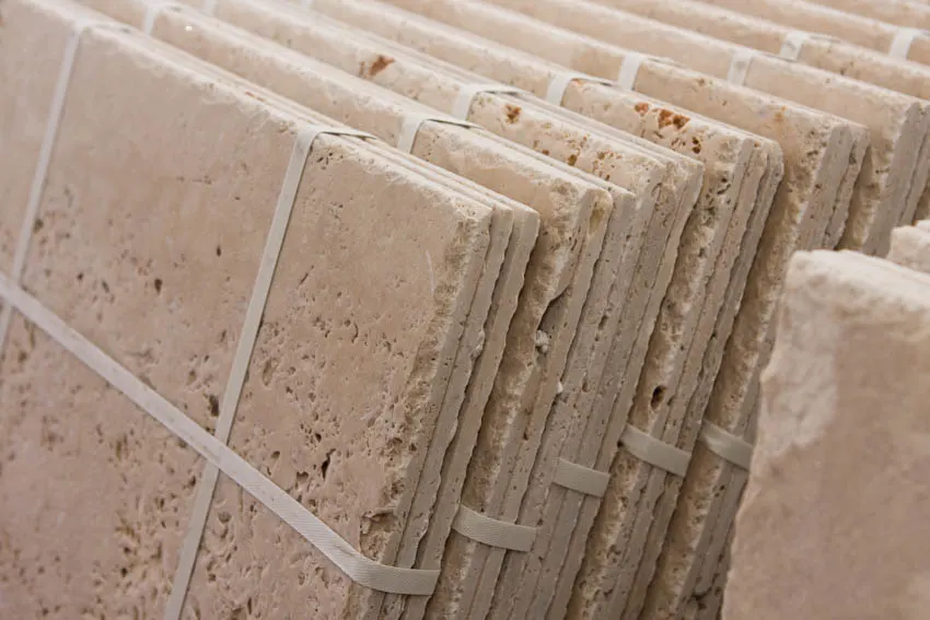 Close up of stack of travertine pieces with holes