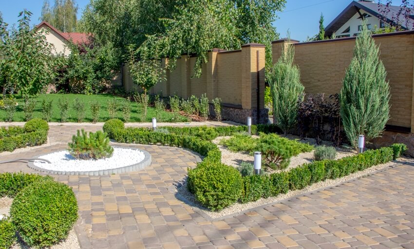 Cobbled concrete paving slab track in a beautifully landscaped garden