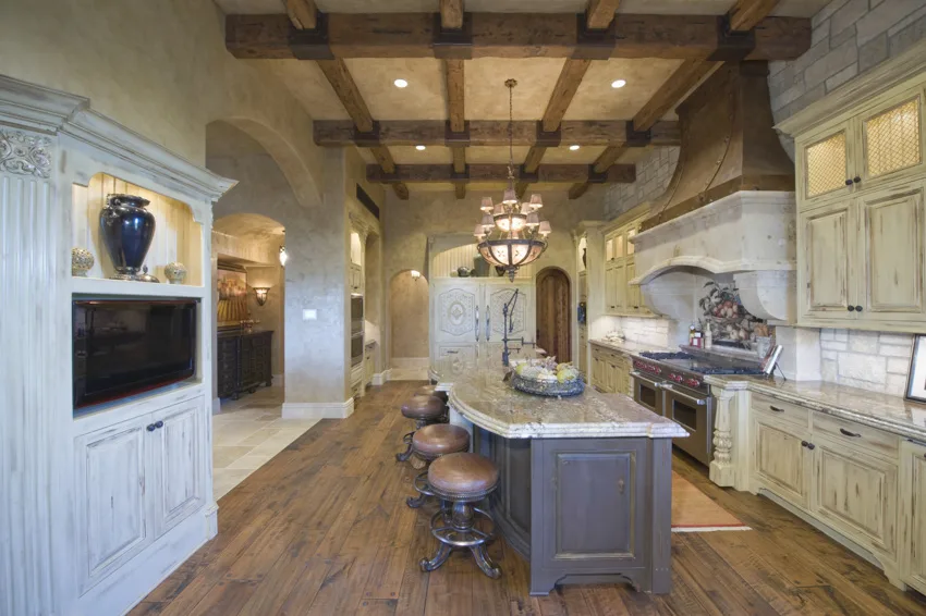 Coffered ceiling center island wood floor white cabinets tuscan kitchen