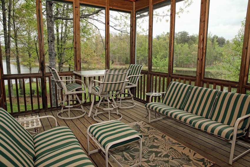 Cozy porch turned into room with sofa chairs table footrest rug