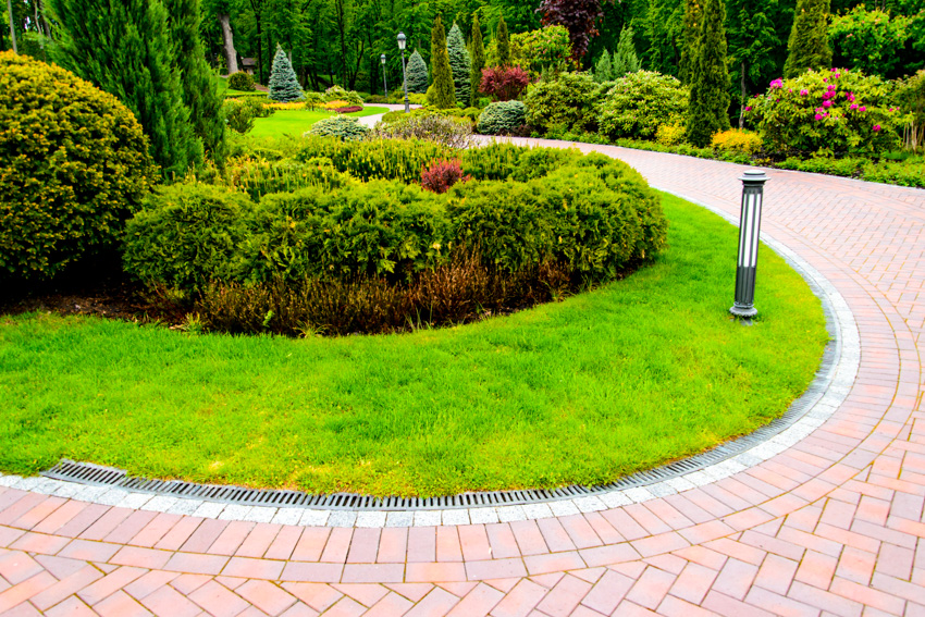 Curving bricklandscaped area light mounted on path