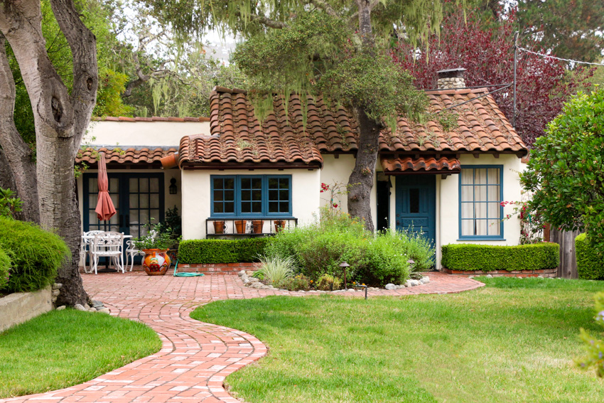 Curving front yard walkway made of bricks leading to house