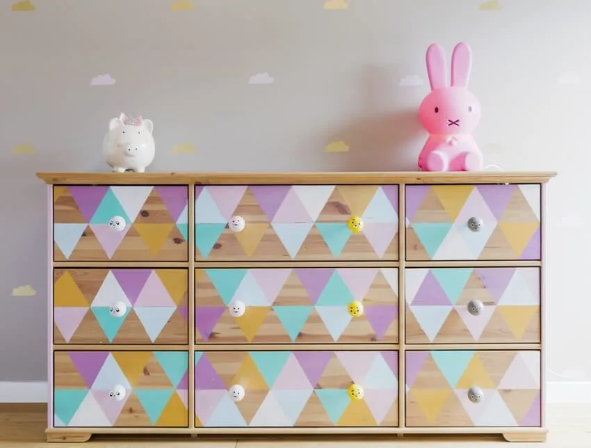 DIY colorful patterned dresser with toys in pastel girl room